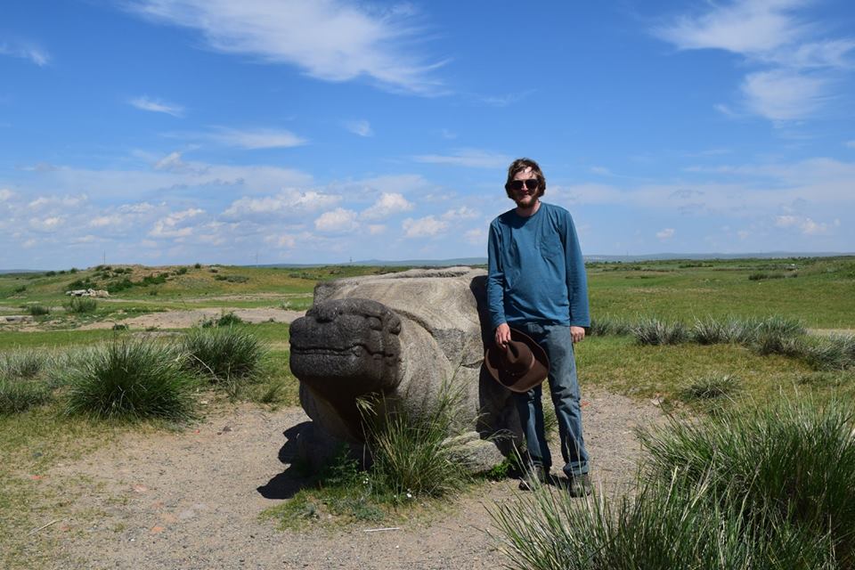 a man by a sculpted rock